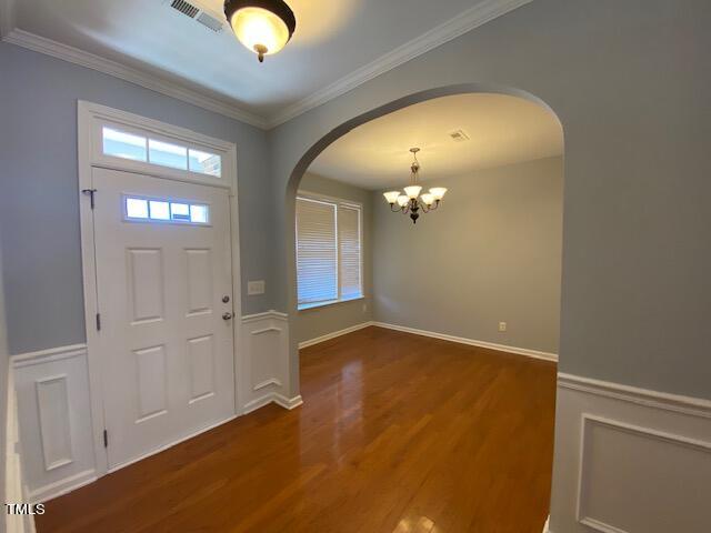 10103 Falls Meadow Court Raleigh, NC 27617 - Photo 20 of 54 a view of an empty room with chandelier fan and wooden floor