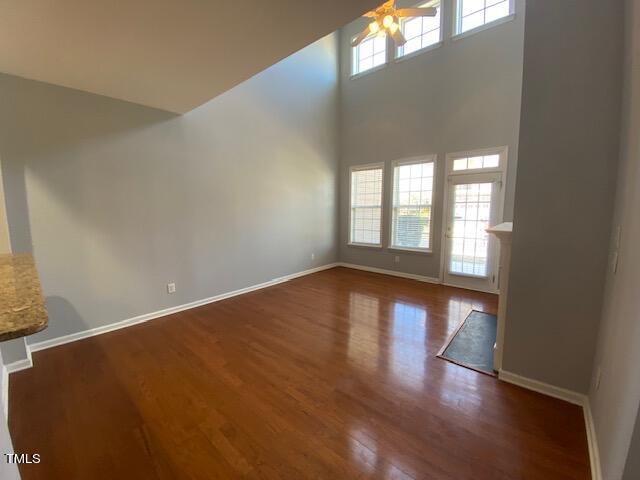 10103 Falls Meadow Court Raleigh, NC 27617 - Photo 2 of 54 a view of an empty room with wooden floor and a window