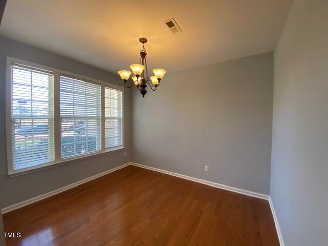 10103 Falls Meadow Court Raleigh, NC 27617 - Photo 22 of 54 wooden floor in an empty room with a window