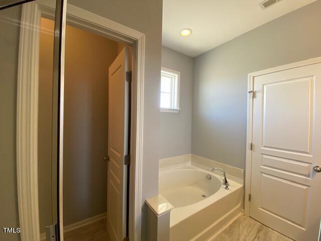 10103 Falls Meadow Court Raleigh, NC 27617 - Photo 40 of 54 a bathroom with a tub and shower