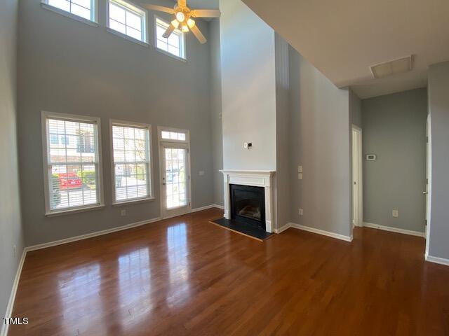 10103 Falls Meadow Court Raleigh, NC 27617 - Photo 6 of 54 an empty room with wooden floor fireplace and windows