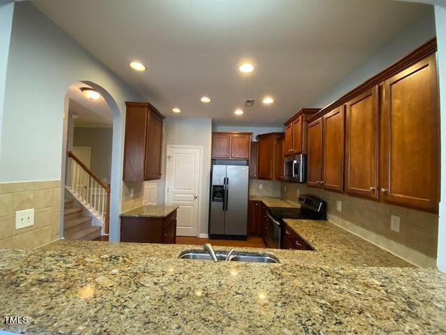 10103 Falls Meadow Court Raleigh, NC 27617 - Photo 9 of 54 a view of a kitchen with a stove and refrigerator