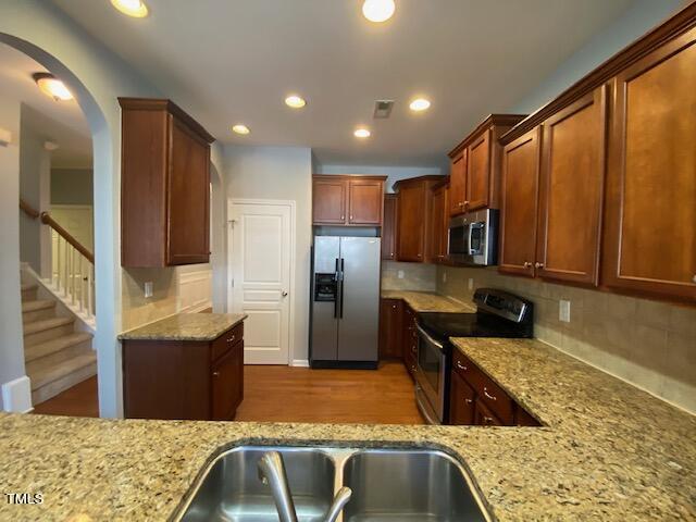 10103 Falls Meadow Court Raleigh, NC 27617 - Photo 10 of 54 a kitchen with stainless steel appliances granite countertop sink refrigerator and microwave
