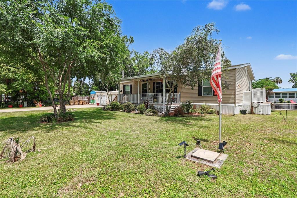 56348 Maple Road Astor, FL 32102 - Photo 54 of 66 a view of a house with backyard and a tree