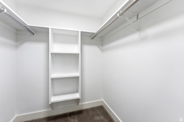 871 Bonita Way Centerville, UT 84014 - Photo 37 of 61 White-painted closet featuring built-in shelving, two clothing rods, and carpeting