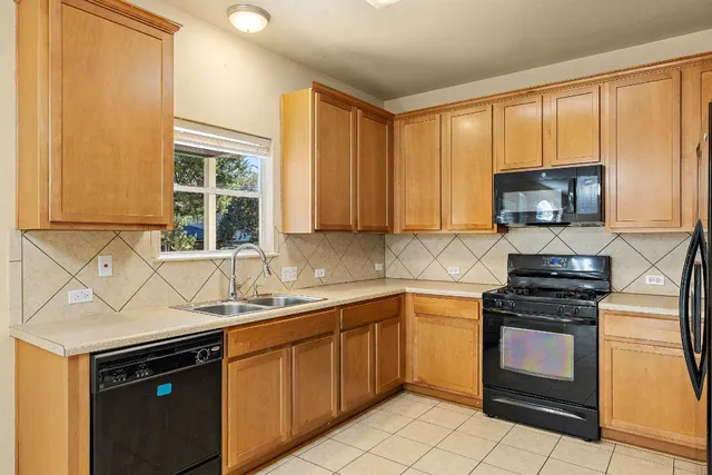 a kitchen with a sink stove and microwave