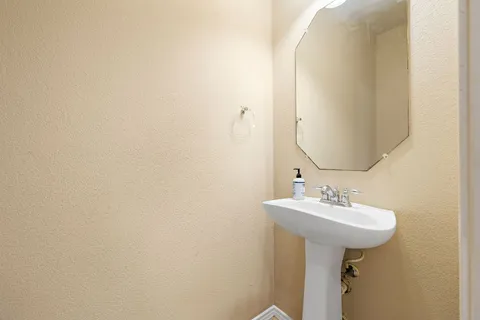 a bathroom with a sink a mirror and a toilet