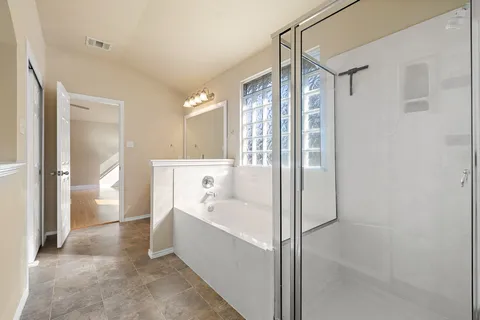 a bathroom with a bathtub and a shower