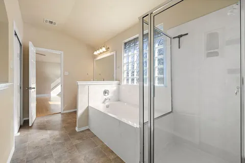 a bathroom with a bathtub and a shower