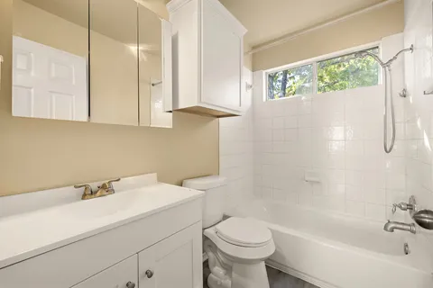 a bathroom with a sink a toilet and bathtub
