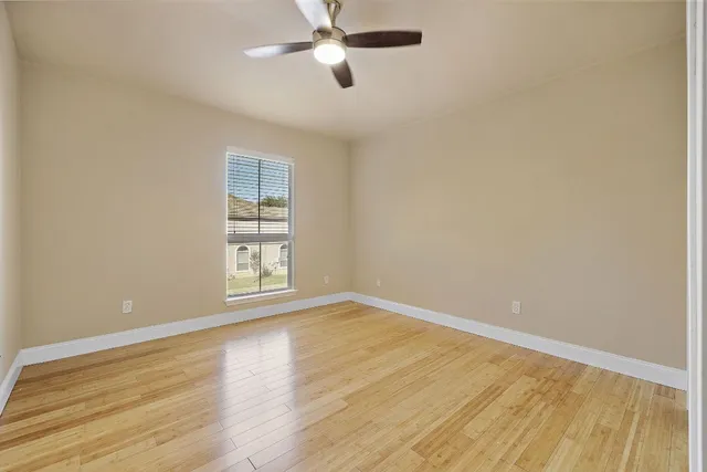 wooden floor in an empty room with a window