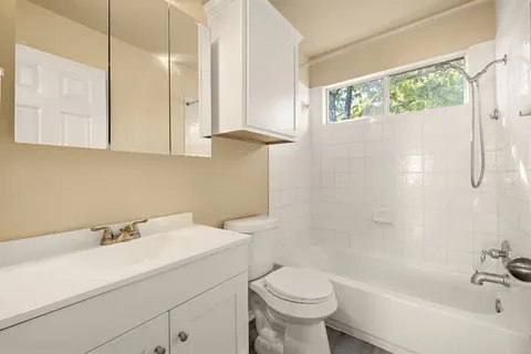 a bathroom with a sink a toilet and bathtub