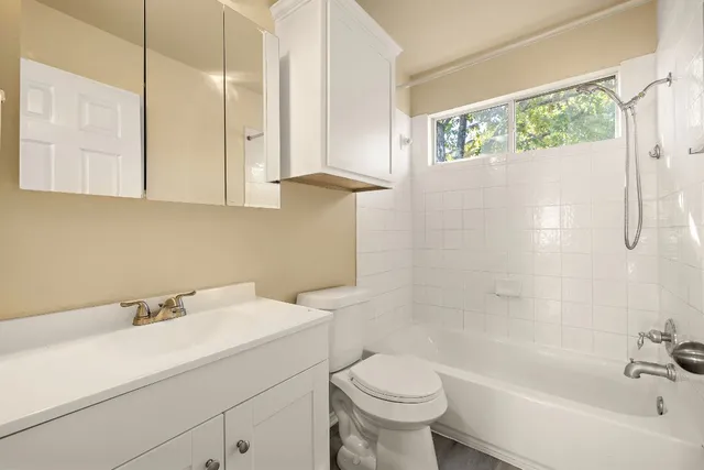 a bathroom with a sink a toilet and bathtub