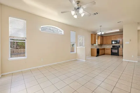 a view of a kitchen with furniture and a ceiling fan