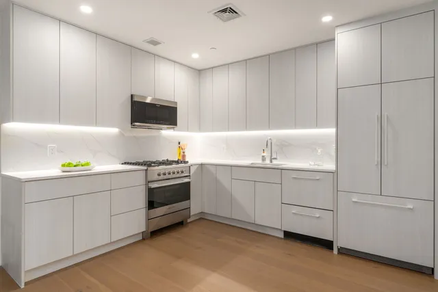 a kitchen with a sink and white cabinets