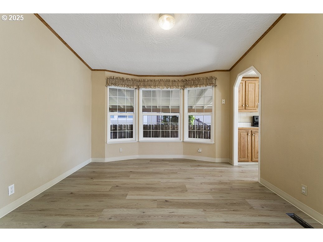 1949 Southeast Palmquist Road, Unit 100 Gresham, OR 97080 - Photo 17 of 28 a view of an empty room with wooden floor and a window