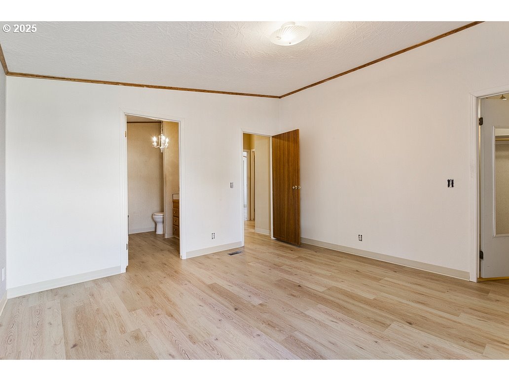 1949 Southeast Palmquist Road, Unit 100 Gresham, OR 97080 - Photo 19 of 28 a view of an empty room with wooden floor