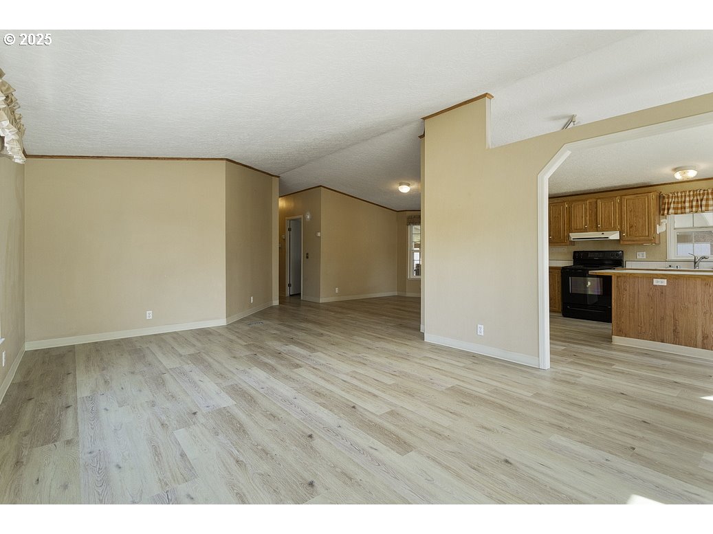 1949 Southeast Palmquist Road, Unit 100 Gresham, OR 97080 - Photo 7 of 28 a view of a kitchen cabinets and wooden floor