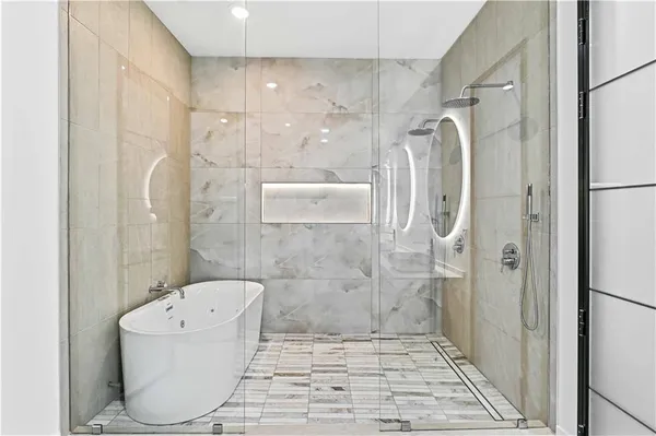 a bathroom with a bathtub and a shower