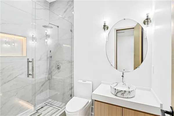 a bathroom with a toilet sink and shower