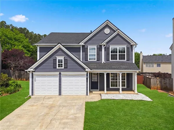 a front view of a house with a yard