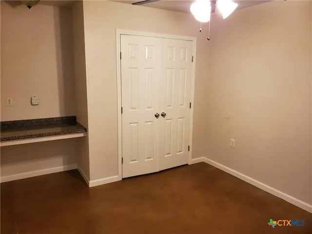 an empty room with closet area