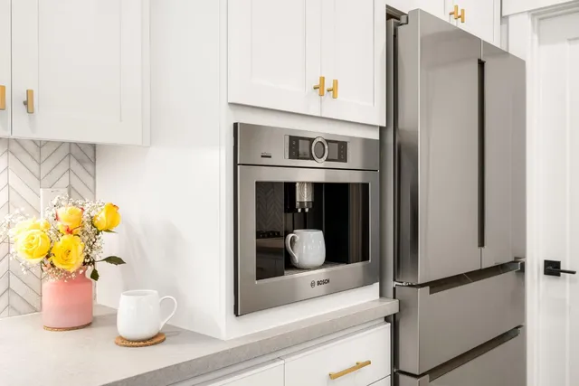 a kitchen with stainless steel appliances kitchen island granite countertop a kitchen island hardwood floor and a sink