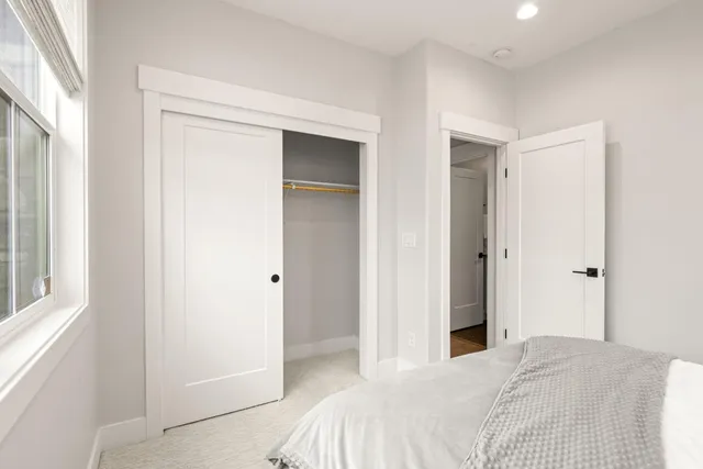 a bedroom with a bed window and wall painting