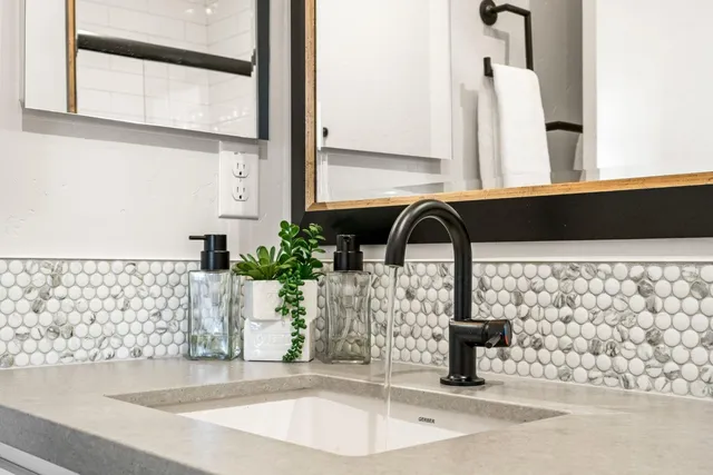 a bathroom with a shower sink and mirror