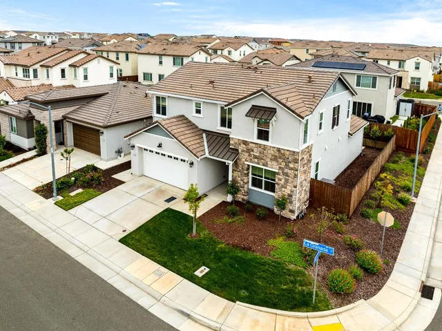 a front view of a house with a garden