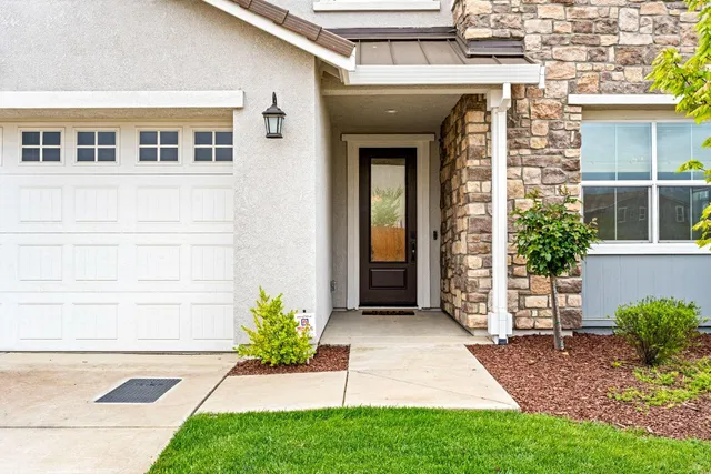 a view of a hallway with furniture and a potted plant