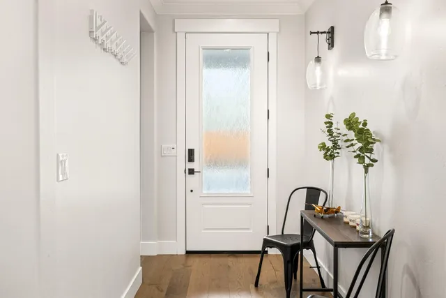 a view of a workspace room with furniture and wooden floor