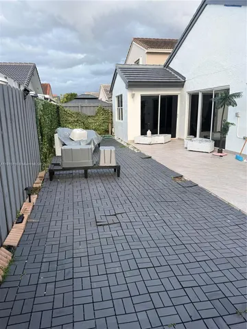 a view of a patio with a table and chairs