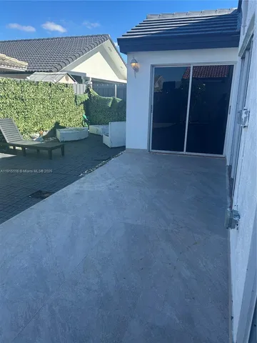 a view of backyard with seating space