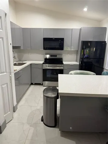 a kitchen with a sink and a stove top oven