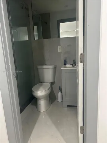 a white toilet sitting next to a bathroom sink