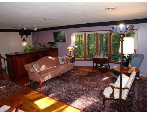 68 Highland Road Boxford, MA 01921 - Photo 3 of 17 a living room with furniture a floor to ceiling window and a flat screen tv