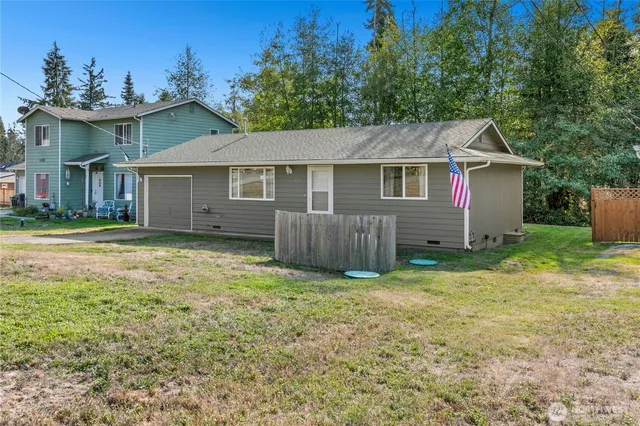 a view of a house with a yard and fence