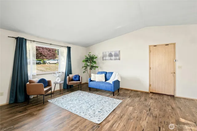 a living room with furniture and a rug