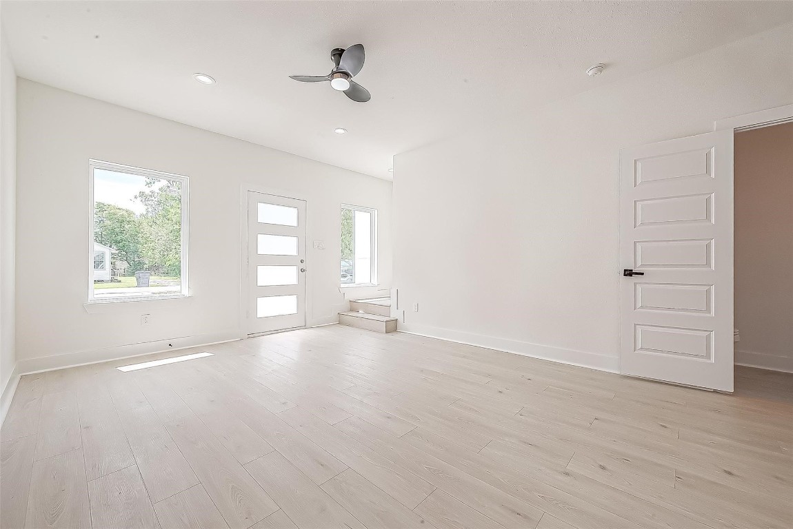 4135 Mallow Street, Unit B Houston, TX 77051 - Photo 6 of 11 an empty room with wooden floor and windows