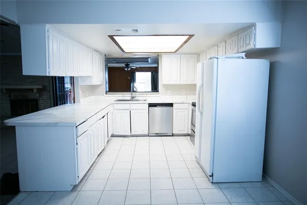 a kitchen with a sink a refrigerator and a stove
