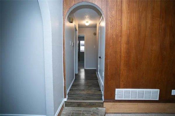 a view of a hallway with wooden floor