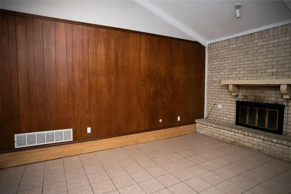 a view of an empty room with a fireplace