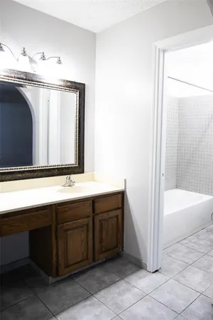 a bathroom with a double vanity sink and a bathtub