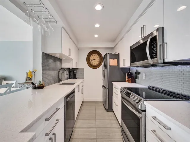 a kitchen with a stove a sink and a refrigerator