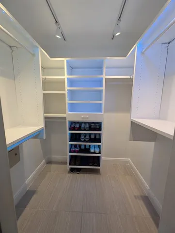 a dining room with furniture a chandelier and wooden floor