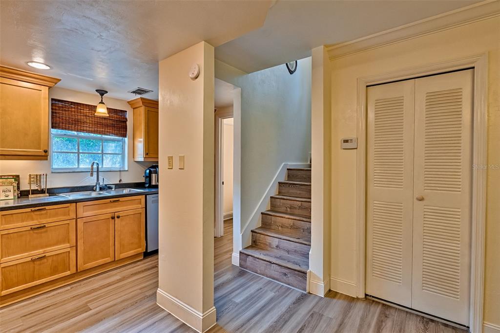 2338 Southwest 73rd Terrace Gainesville, FL 32607 - Photo 11 of 29 a view of a kitchen with wooden floor and staircase