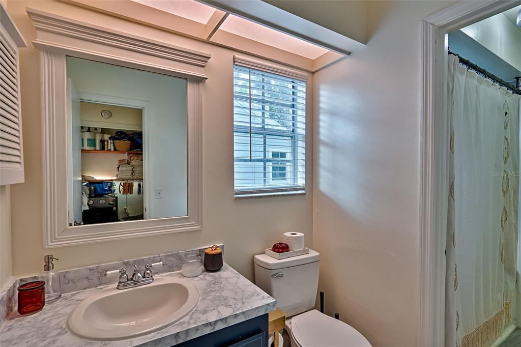 2338 Southwest 73rd Terrace Gainesville, FL 32607 - Photo 15 of 29 a bathroom with a granite countertop sink vanity mirror and toilet
