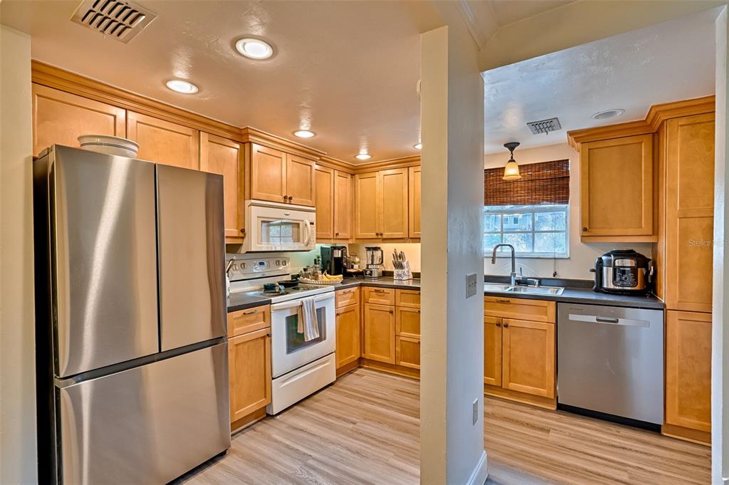 2338 Southwest 73rd Terrace Gainesville, FL 32607 - Photo 8 of 29 a kitchen with stainless steel appliances granite countertop a refrigerator stove and sink