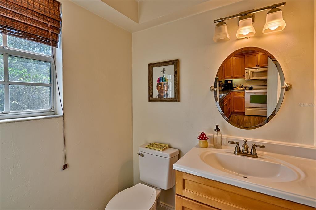 2338 Southwest 73rd Terrace Gainesville, FL 32607 - Photo 10 of 29 a bathroom with a toilet sink and mirror